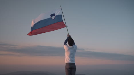 Hiker-holding-a-pole-in-the-air-with-a-hiking-pole-to-let-it-flutter-in-the-wind