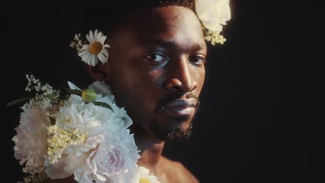 creative portrait of confident black man with flower adornment