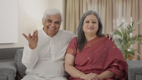 Happy-Old-Indian-couple-talking-to-the-camera