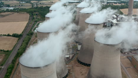 drone shot over large power plant cooling towers