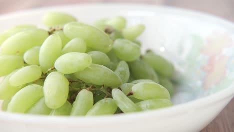 green grapes in a white bowl