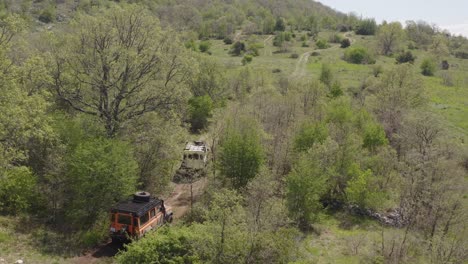 Beautiful-footage-from-a-drone,-Land-Rovers-driving-on-the-road-in-beautiful-nature