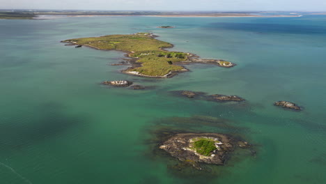 tropical isolated islands in turquoise ocean water in bluff area, new zealand, oceania