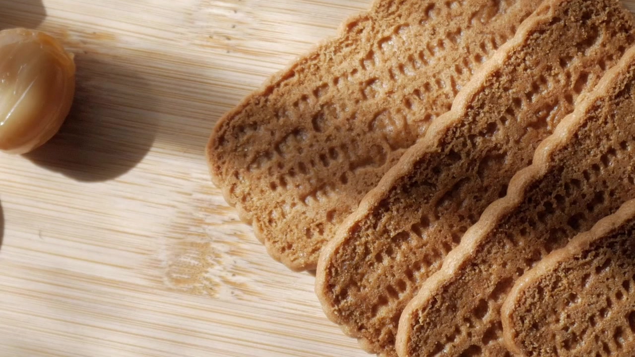 Sliced biscuit on a light wooden table, warm and inviting