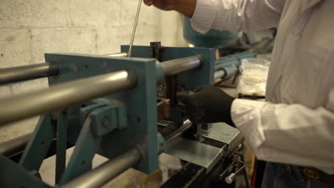 a fully functional hydraulic machine and a worker working on the creation of a plastic device