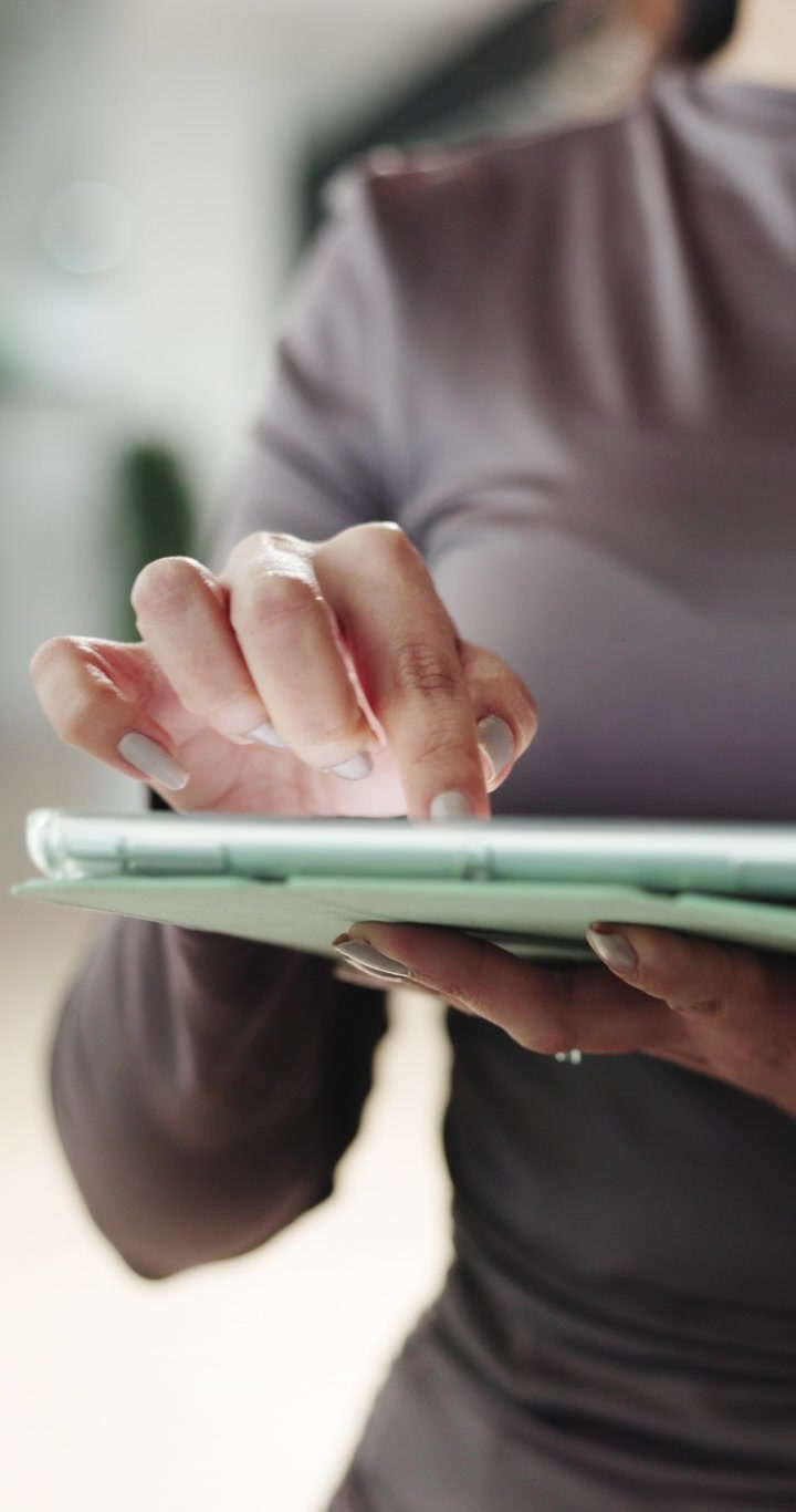 Close-up of Woman Using Tablet in Office