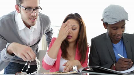 Design-team-working-together-at-table-looking-at-jewlery