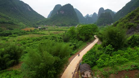 Aerial-shot-of-an-electric-motorbike-driving-on-mountain-road