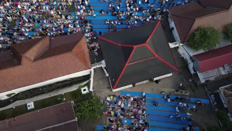 aerial view, worshipers praying eid al-adha or eid al-fitr in the courtyard of the kauman mosque in yogyakarta