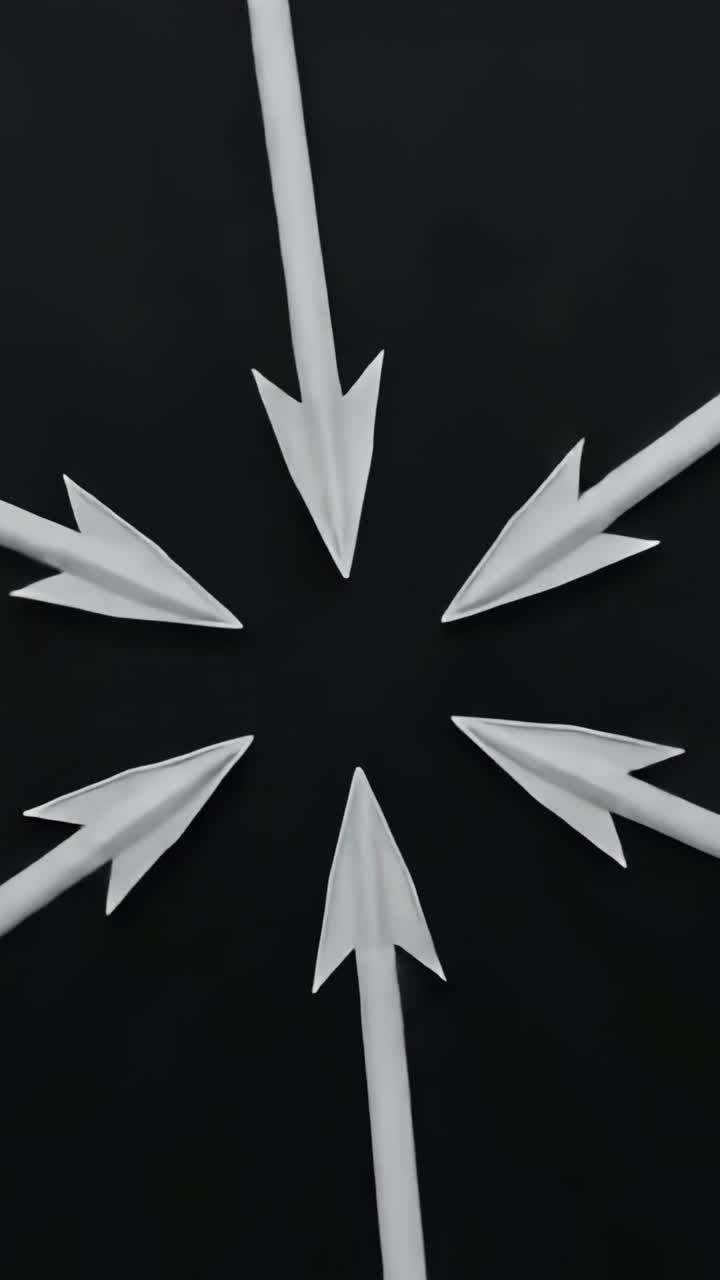 Vertical video: Starting animation illustrating six white paper arrows spinning clockwise on black