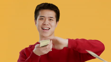 man throwing money in the air