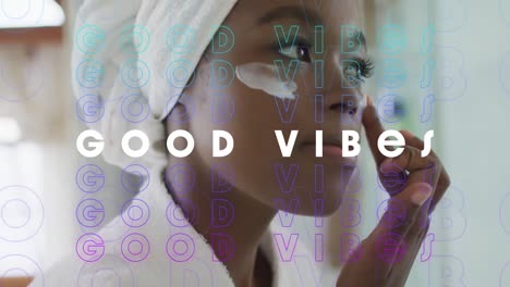 animación de buenas vibraciones texto sobre mujer afroamericana usando crema en el baño