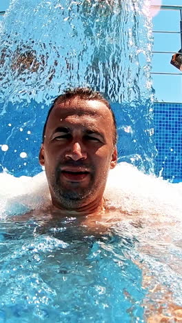 man refreshing on vacation. selfie shot of man in water surface at pool