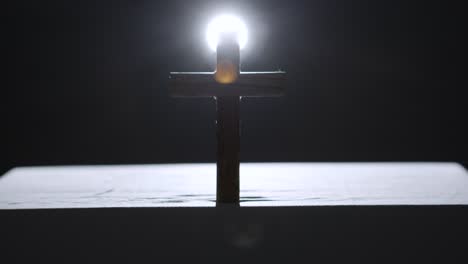 religious concept shot with wooden cross on altar with spotlight behind 2