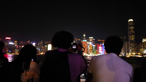 people enjoying hong kong's illuminated skyline