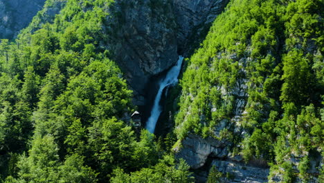 popular savica waterfall surrounded with green forest at the cliff in triglav national park in slovenia