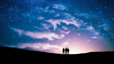 three people gazing at the starry night sky