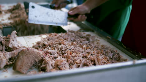 tight shot of chopping pulled pork bbq