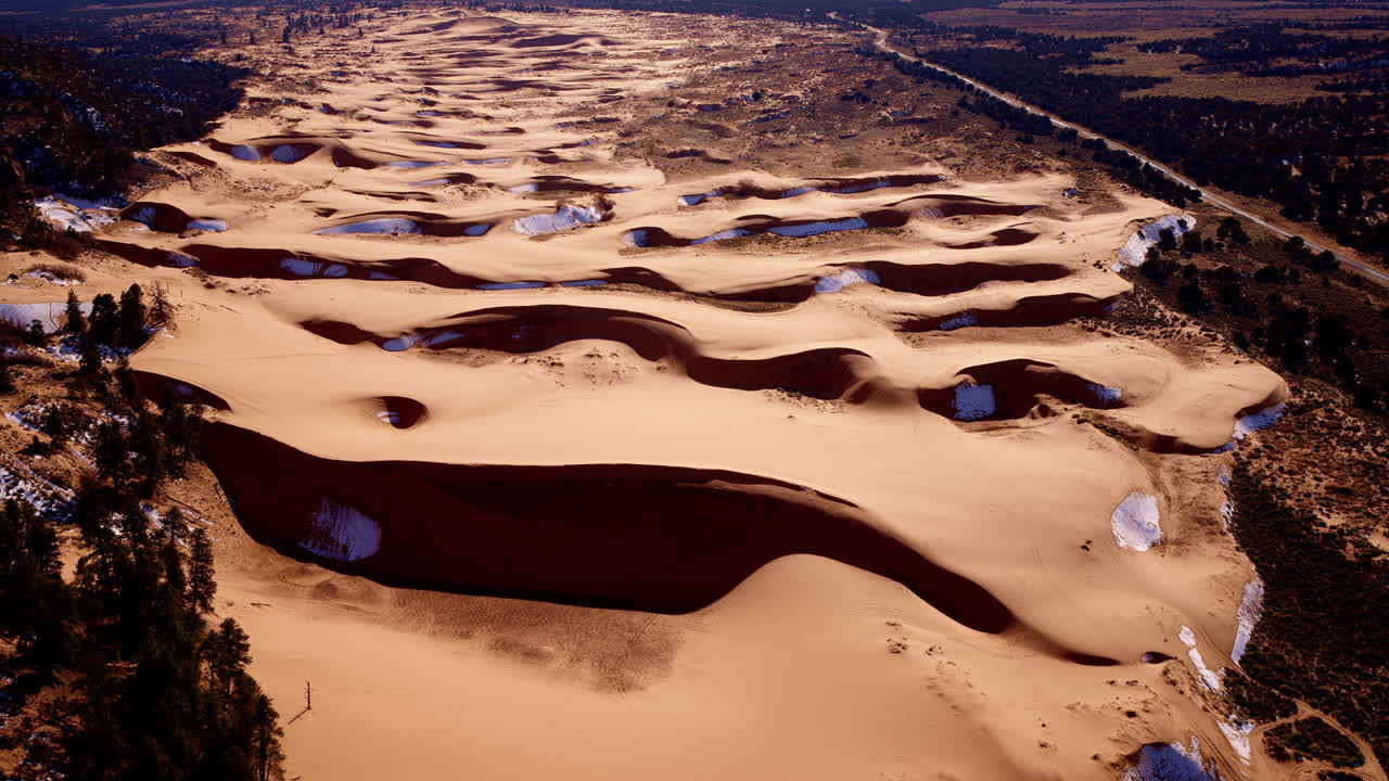 Drone view looking straight down onto a dreamscape of pink sand and dynamic shapes in southern Utah.