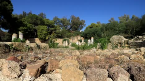 Low-angle-view-of-ancient-Roman-ruins-in-Carthage,-Tunisia-under-blue-sky