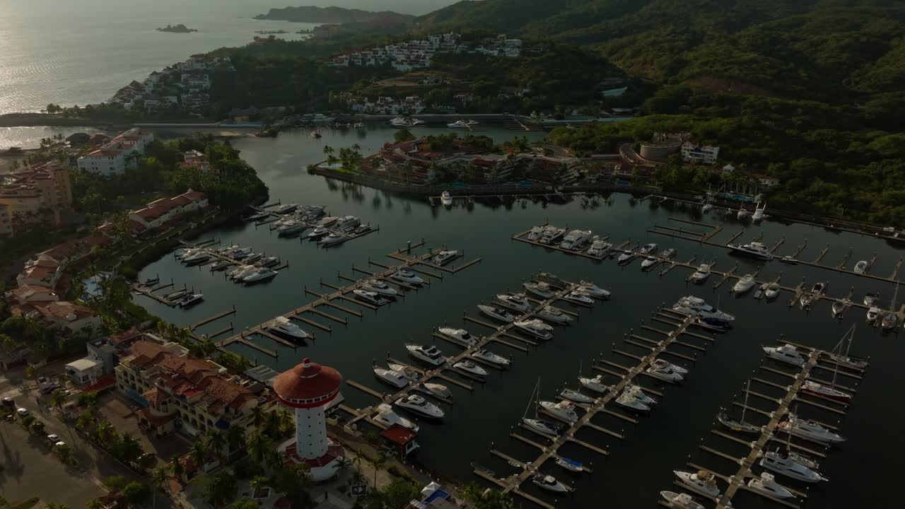 DRONE: HIGH ALTITUDE DRONE SHOT OF IXTAPA, ZIHUATANEJO MARINA AT SUNSET IN MEXICO