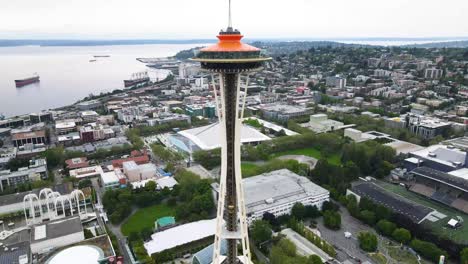 a drone fly by shot of space needle observation deck building in seattle washington, united states of america