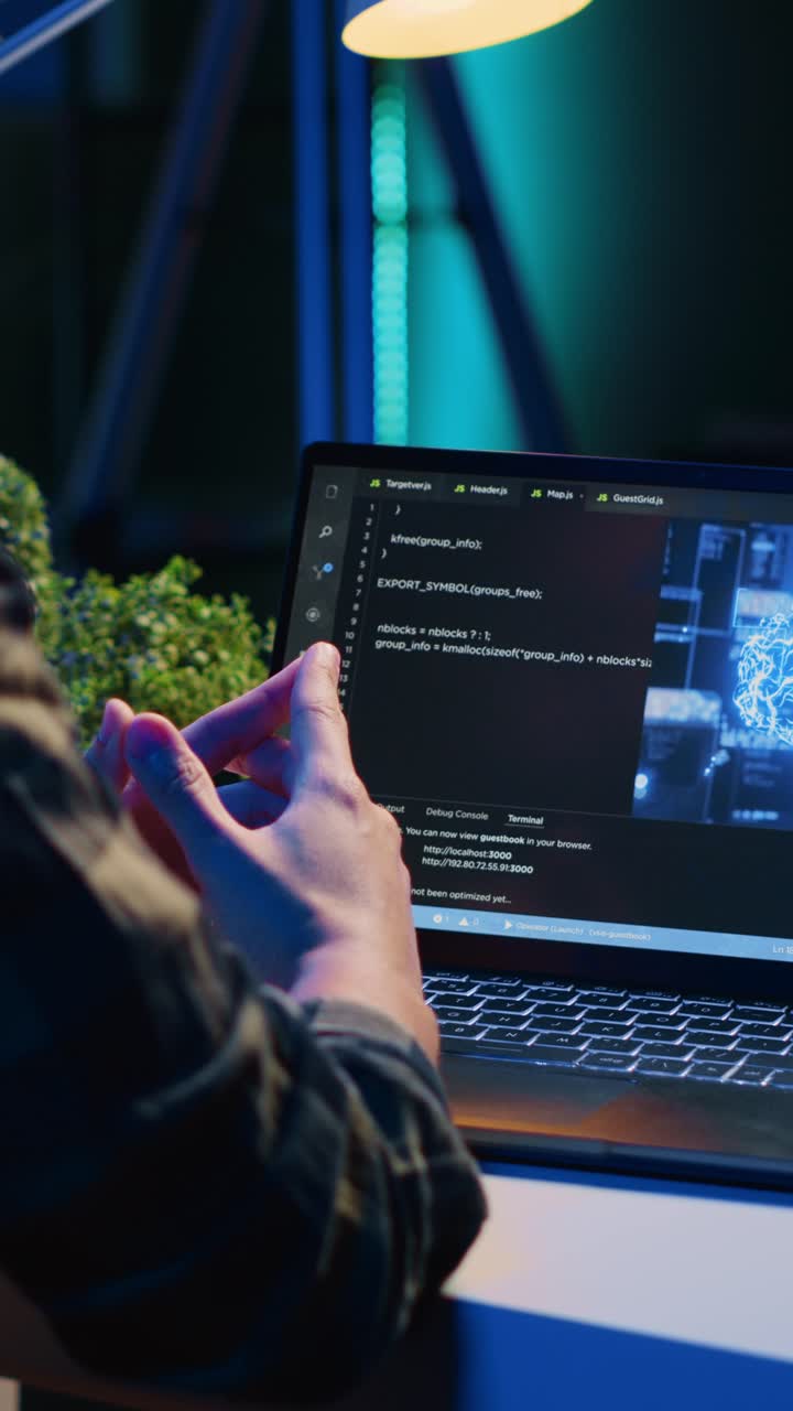 Vertical video Teleworking IT specialist in apartment office uses programming to upgrade AI