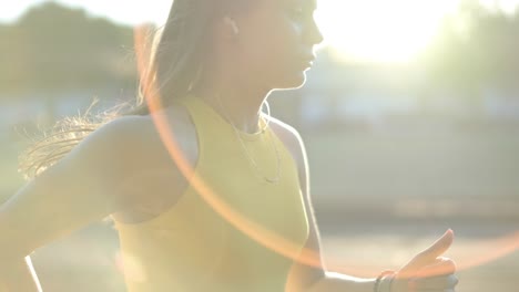 woman jogging on outdoor track in sportswear at athletic field