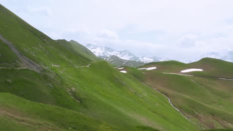 Aerial:-European-Alps-mountains,-remote-landscape-with-snowy-mountain-backdrop