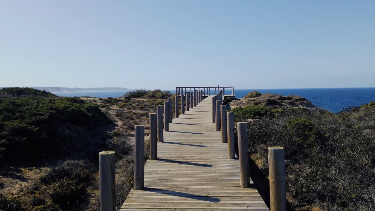 walking on a wooden footpath between poles