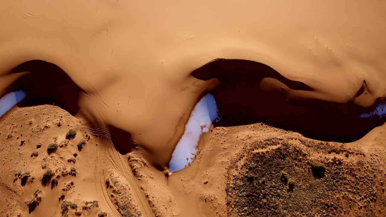 Straight-down drone footage reveals a surreal landscape of pink dunes and intricate patterns in southern Utah.