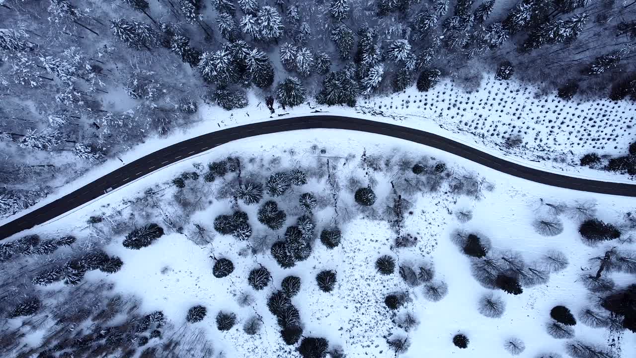 Aerial top down view of snow-capped mountain road in Hautes-Vosges, France