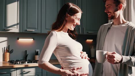 pregnant couple enjoying morning coffee