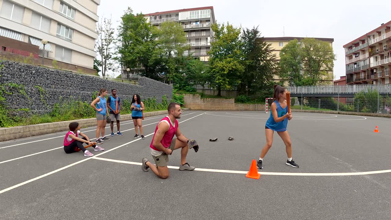 A group of people playing baseball outdoors