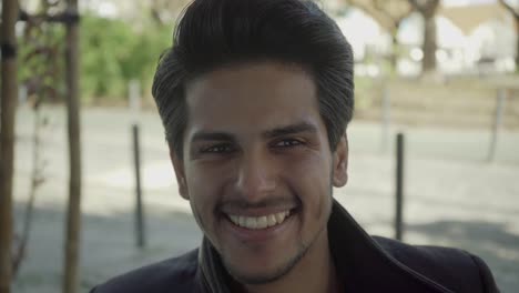 portrait of handsome young man smiling at camera