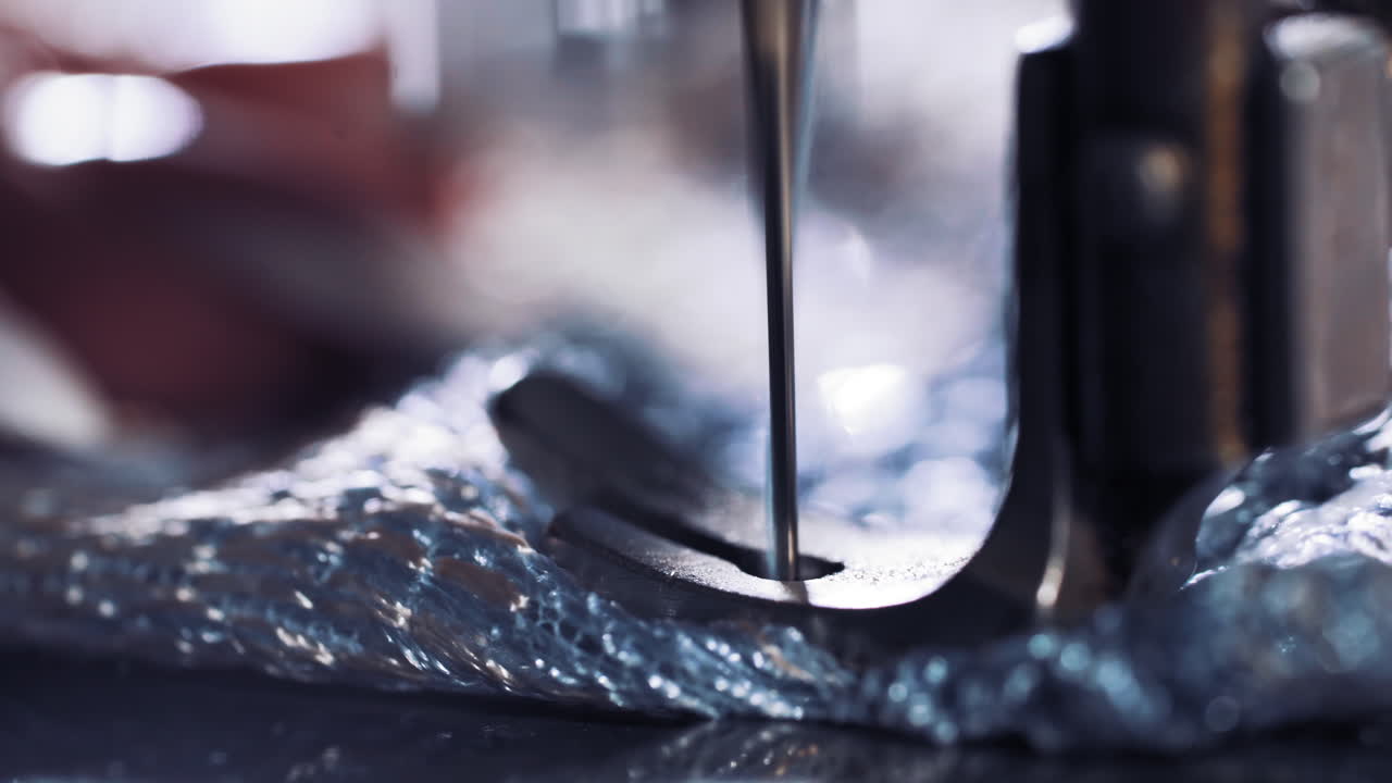 Sewing machine with fabric and thread. Close up view of production line sewing machine