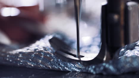 sewing machine with fabric and thread. close up view of production line sewing machine