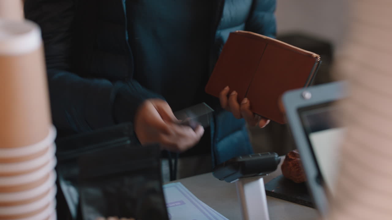 young woman paying using credit card transaction service buying coffee in cafe spending money at restaurant