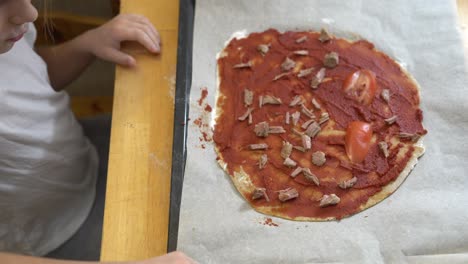 the girl cooking healthy gluten-free pizza with beef. cooking together.