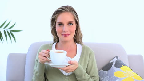 delighted woman drinking a cup of tea