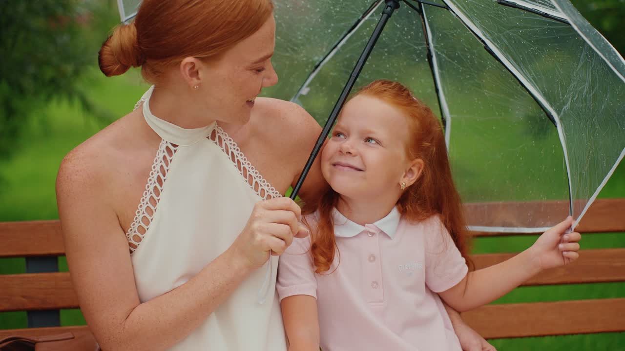 Mother and Daughter Enjoying a Rainy Day
