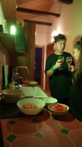 friends celebrating in a kitchen at night