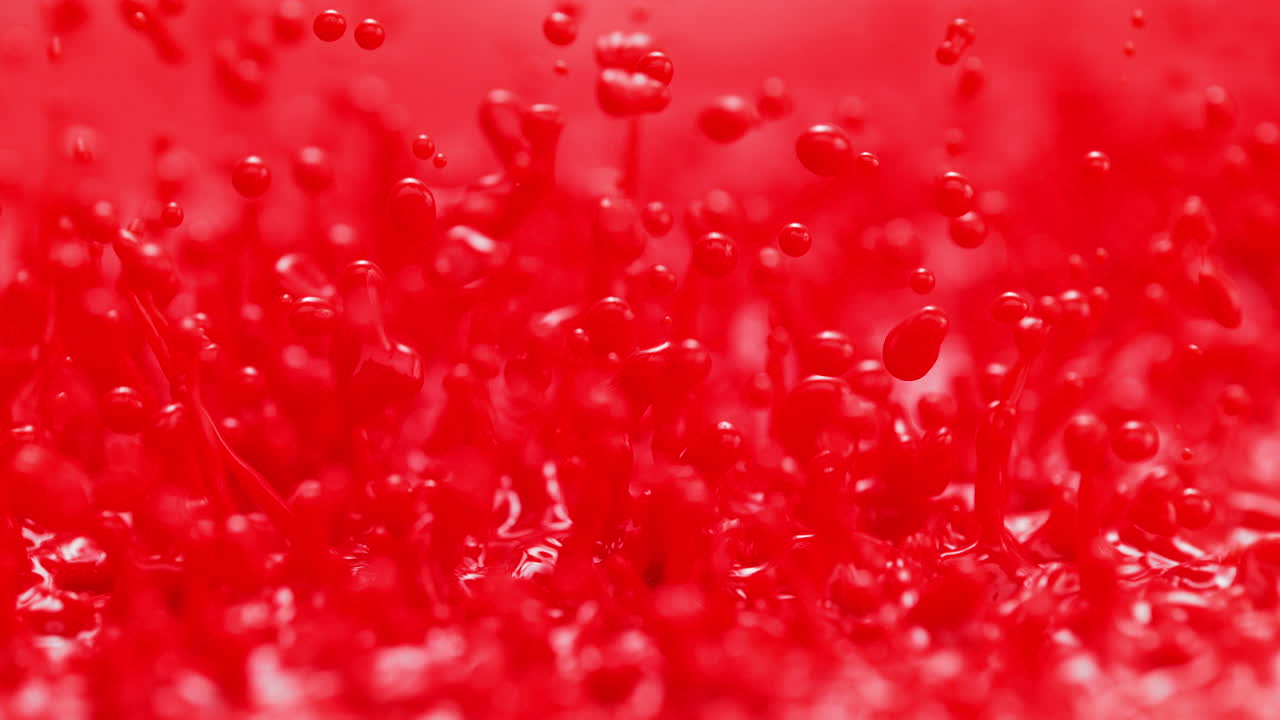 빨간색 페인트 스프레이와 느린 동작과 거시 추상 염색 액체에서 패턴을 만니다.