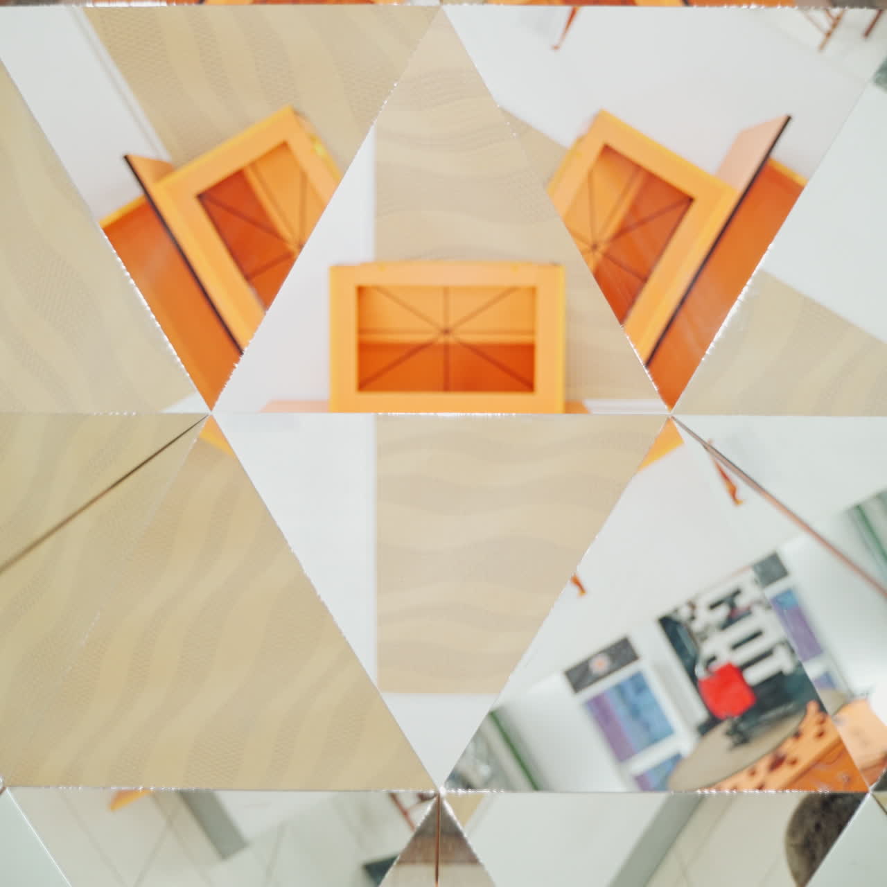 Curious boy in blue and yellow shirt reflecting in the mirrors of kaleidoscope. Abstract montage of a child in many triangle parts of the kaleidoscope.