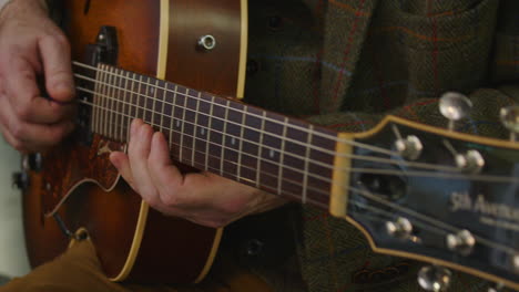 jazz guitar, archtop, f soundhole  being played