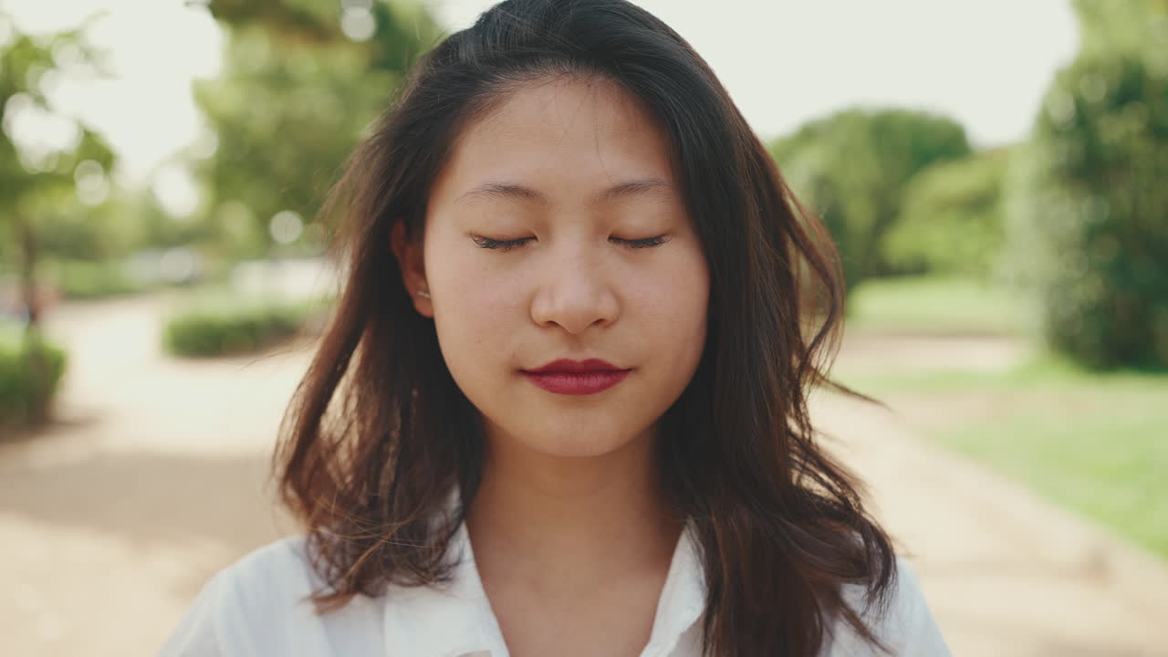 Portrait of Asian Woman with Eyes Closed