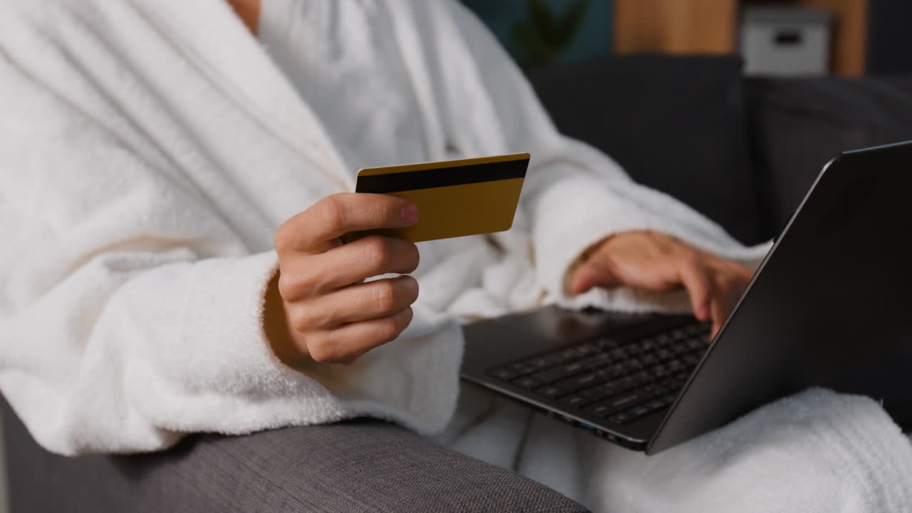 Person using credit card and laptop for online shopping