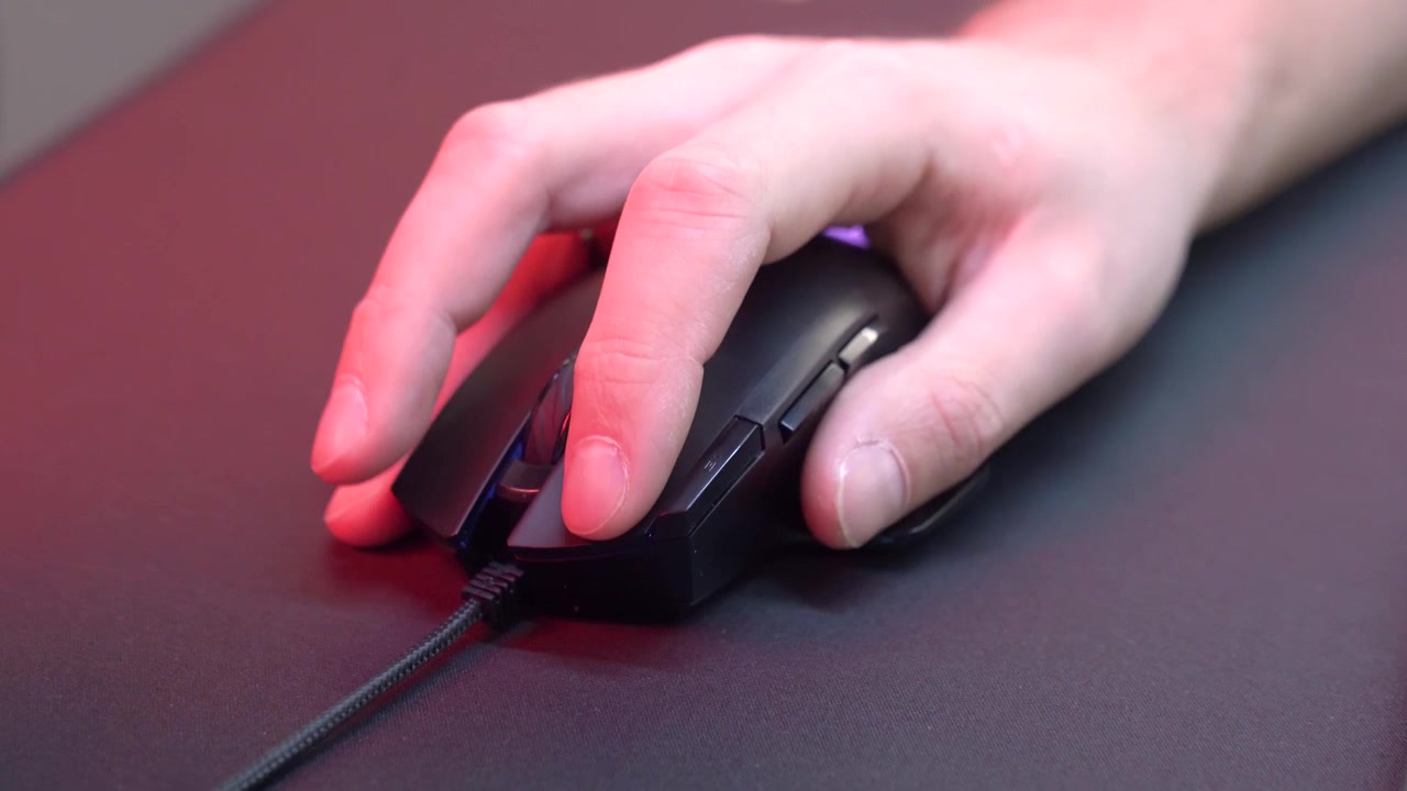 Close-up of Hand Clicking and Scrolling a Gaming Mouse with RGB Lighting