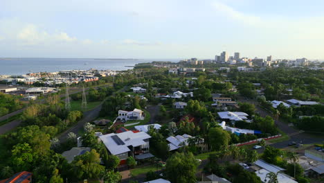 Aerial-drone-of-Stunning-Coastal-Surburb-With-City-During-Sunset-Sunrise-Golden-Hour,-Panoramic-Establishing-Overview