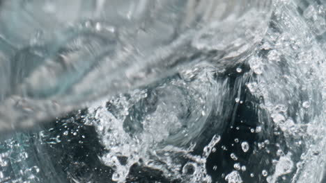 filtered liquid filling container closeup. fresh beverage pouring in glassware